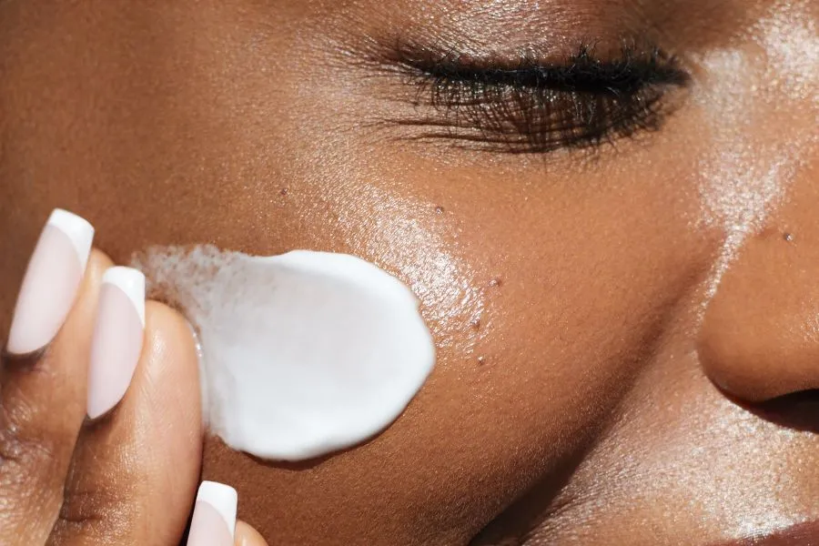 A swipe of cream on a woman's cheek.